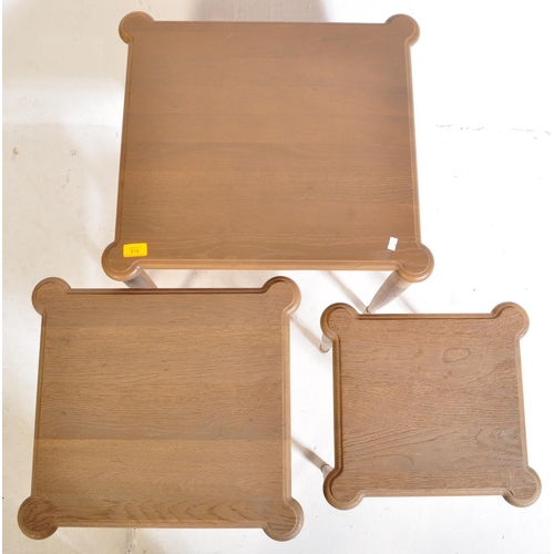 1044 - A retro 20th century oak wood nest of graduating tables. The tables being raised on turned and taper... 