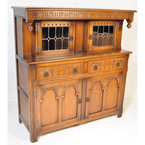 1056 - Wood Bros - Old Charm Furniture A 20th century Jacobean revival oak court cupboard by Old Charm Wood... 