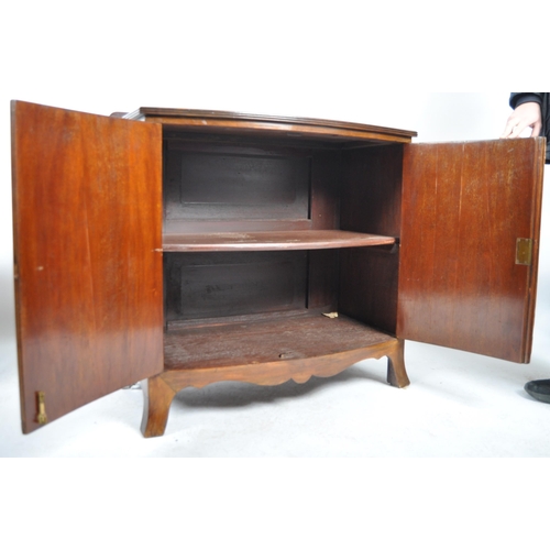 1066 - An Edwardian mahogany bow fronted sideboard cabinet. Raised on bracket feet with a bow fronted body ... 