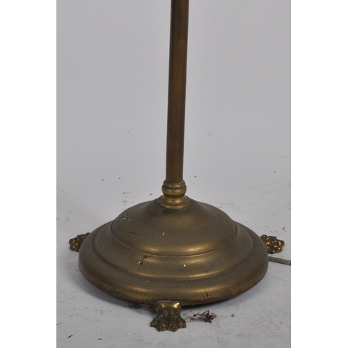1071 - A 19th century Victorian brass hairy paw feet floor standing standard lamp. Raised  on a stepped cir... 