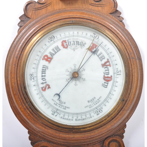 1073 - Early 20th century large oak aneroid wall barometer - thermometer banjo shaped compendium. Carved oa... 