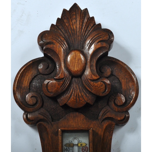 1073 - Early 20th century large oak aneroid wall barometer - thermometer banjo shaped compendium. Carved oa... 