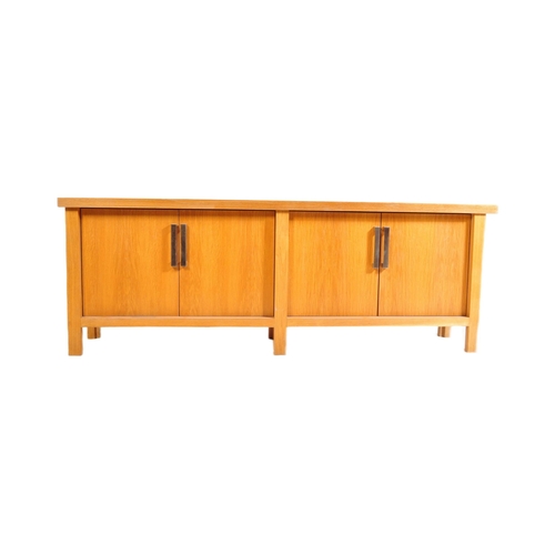 615 - A contemporary oak furniture style sideboard credenza. Of rectangular form with two twin cupboard do... 