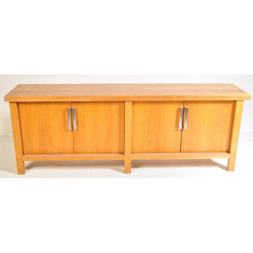 615 - A contemporary oak furniture style sideboard credenza. Of rectangular form with two twin cupboard do... 