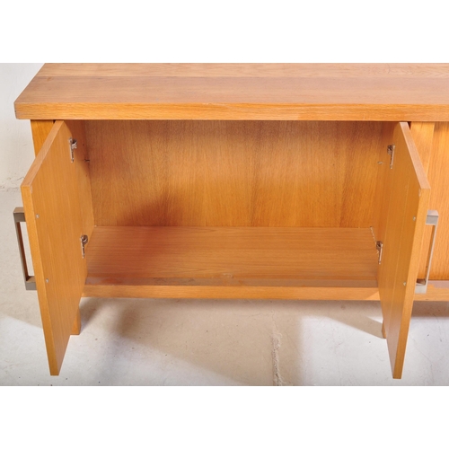 615 - A contemporary oak furniture style sideboard credenza. Of rectangular form with two twin cupboard do... 
