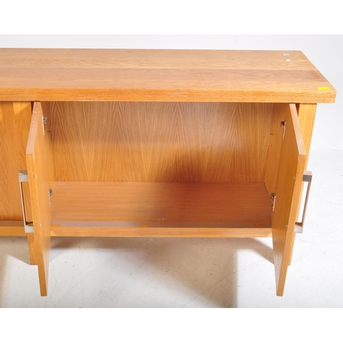 615 - A contemporary oak furniture style sideboard credenza. Of rectangular form with two twin cupboard do... 
