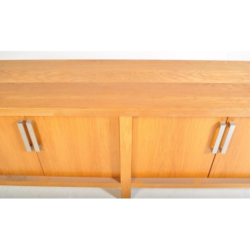 615 - A contemporary oak furniture style sideboard credenza. Of rectangular form with two twin cupboard do... 