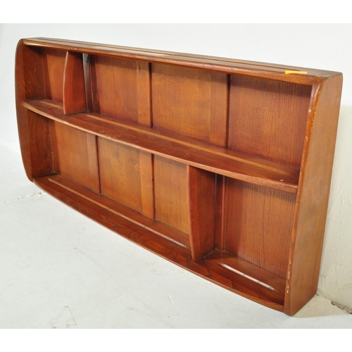 619 - Ercol - A vintage retro mid 20th century light elm wall mounted Ercol plate rack having two bowed sh... 