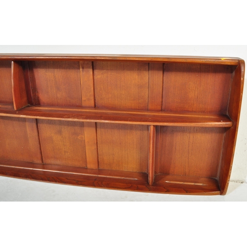 619 - Ercol - A vintage retro mid 20th century light elm wall mounted Ercol plate rack having two bowed sh... 