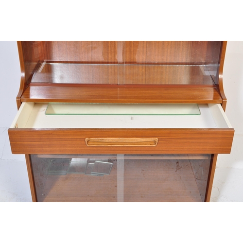 623 - British Modern Design – Mid -century teak veneer drinks display cabinet. Lower sliding door glass ca... 