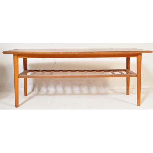 775 - A vintage retro mid 20th century teak surfboard coffee table having a shaped top with rail under tie... 
