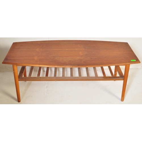 775 - A vintage retro mid 20th century teak surfboard coffee table having a shaped top with rail under tie... 