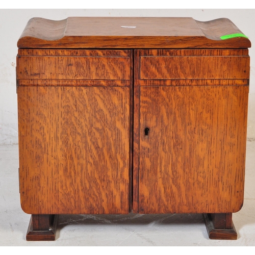 787 - A vintage 20th century circa. 1930's art deco smokers / tobacco cabinet oak cabinet of stepped form.... 