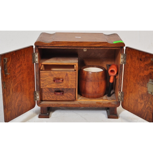 787 - A vintage 20th century circa. 1930's art deco smokers / tobacco cabinet oak cabinet of stepped form.... 