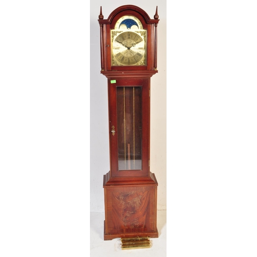 845 - A 20th century longcase grandfather clock. The clock having a gilded face ornate brass spandrels to ... 