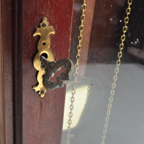 845 - A 20th century longcase grandfather clock. The clock having a gilded face ornate brass spandrels to ... 