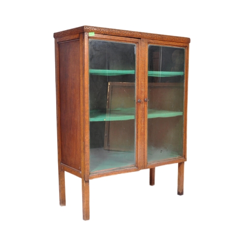 856 - A vintage 20th century 1930's oak glazed cabinet having twin doors opening to reveal a shelved inter... 