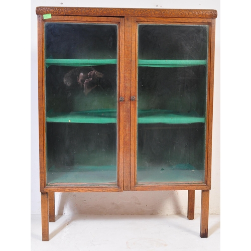 856 - A vintage 20th century 1930's oak glazed cabinet having twin doors opening to reveal a shelved inter... 
