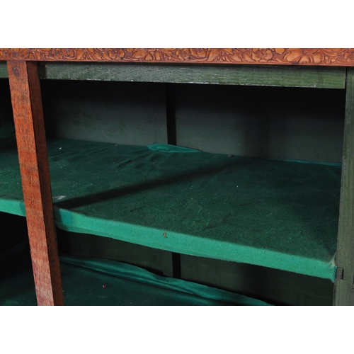 856 - A vintage 20th century 1930's oak glazed cabinet having twin doors opening to reveal a shelved inter... 