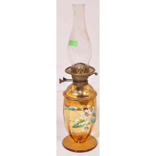 927 - An early 20th century glass oil lamp having a enamelled decorated reservoir in yellow colourway, wit... 