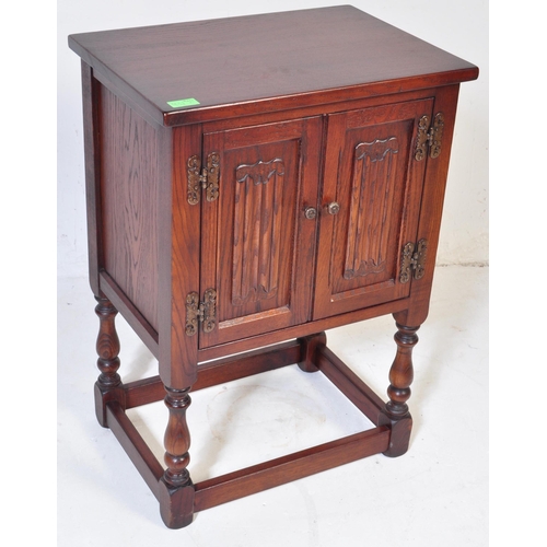 932 - Wood Bros - Old Charm Furniture .A 20th century Jacobean revival  Old Charm oak bedside cabinet / po... 