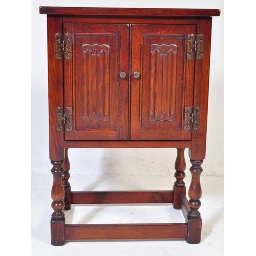 932 - Wood Bros - Old Charm Furniture .A 20th century Jacobean revival  Old Charm oak bedside cabinet / po... 