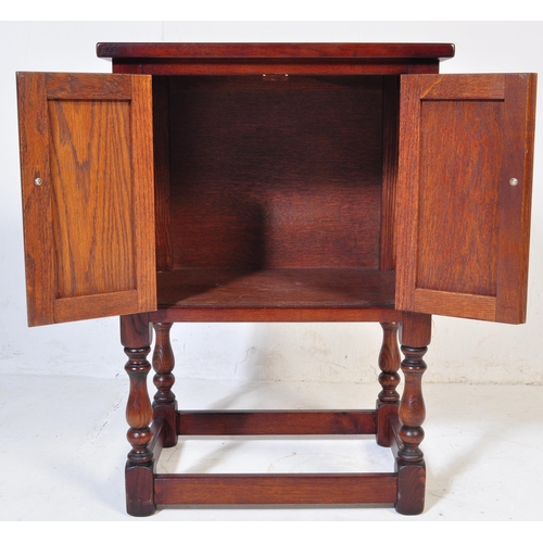 932 - Wood Bros - Old Charm Furniture .A 20th century Jacobean revival  Old Charm oak bedside cabinet / po... 
