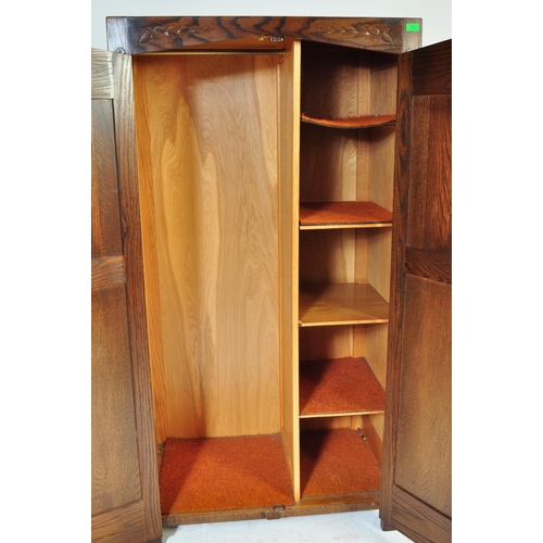 934 - Jacobean revival oak bachelors wardrobe and similar single full size wardrobe, both in the manner of... 