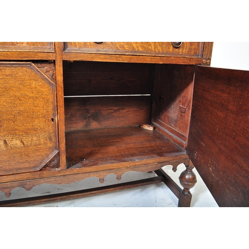 939 - An early 20th century circa. 1920's oak Jacobean Revival sideboard credenza. The sideboard having ga... 