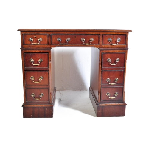 940 - A 20th century George III mahogany and leather twin pedestal kneehole desk. The kneehole desk  havin... 