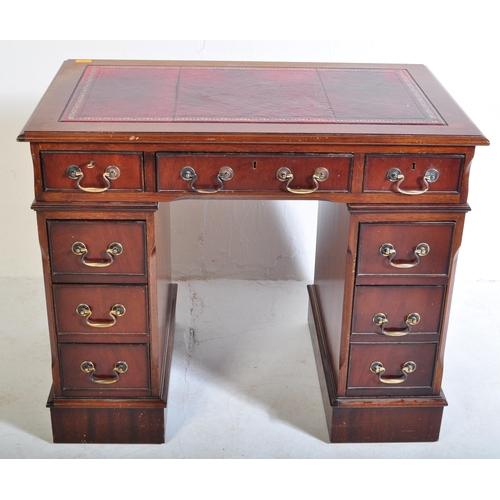 940 - A 20th century George III mahogany and leather twin pedestal kneehole desk. The kneehole desk  havin... 