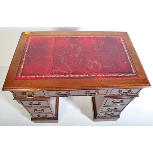 940 - A 20th century George III mahogany and leather twin pedestal kneehole desk. The kneehole desk  havin... 