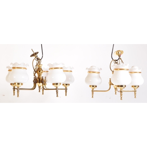 949 - A matching pair of 20th Century brass chandelier ceiling lights. Scrolled arms with opaline glass sh... 