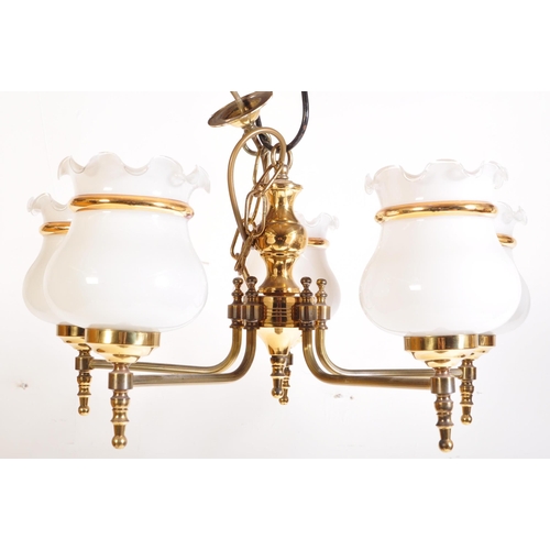 949 - A matching pair of 20th Century brass chandelier ceiling lights. Scrolled arms with opaline glass sh... 