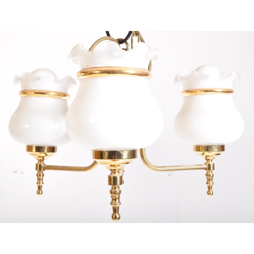 949 - A matching pair of 20th Century brass chandelier ceiling lights. Scrolled arms with opaline glass sh... 
