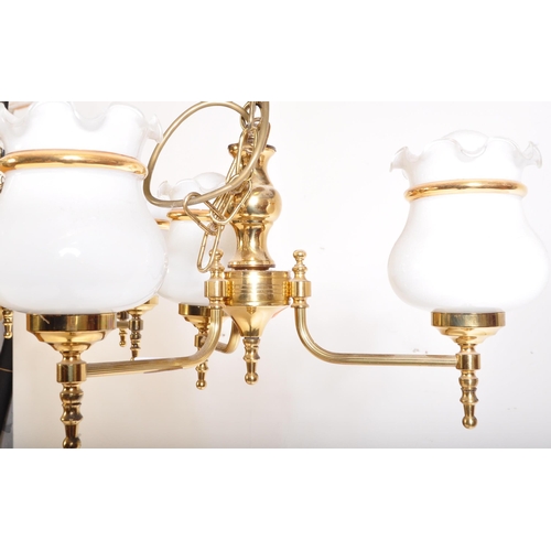 949 - A matching pair of 20th Century brass chandelier ceiling lights. Scrolled arms with opaline glass sh... 