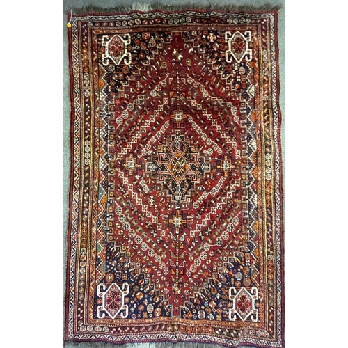 953 - A vintage 20th century Persian Nomadic Qashqai hand knotted floor carpet rug having a dark central m... 