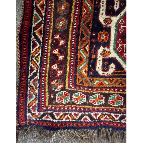 953 - A vintage 20th century Persian Nomadic Qashqai hand knotted floor carpet rug having a dark central m... 