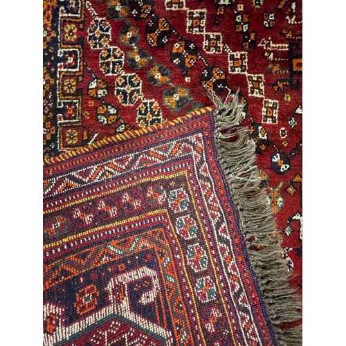 953 - A vintage 20th century Persian Nomadic Qashqai hand knotted floor carpet rug having a dark central m... 