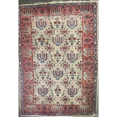 954 - An early 20th century Persian Iran Djoscheghan floor carpet rug having repeating foliate patterns th... 