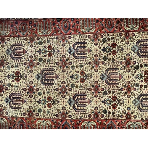 954 - An early 20th century Persian Iran Djoscheghan floor carpet rug having repeating foliate patterns th... 