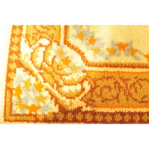 956 - A vintage 20th century Persian Islamic floor carpet rug having earthy ground colours with floral sty... 