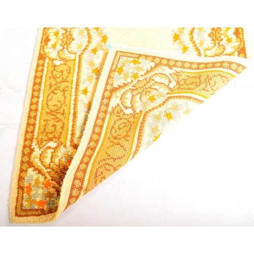 956 - A vintage 20th century Persian Islamic floor carpet rug having earthy ground colours with floral sty... 