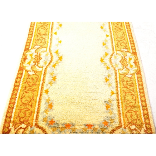 956 - A vintage 20th century Persian Islamic floor carpet rug having earthy ground colours with floral sty... 