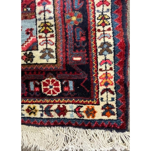 958 - A vintage mid 20th century Persian Islamic Hamadan floor carpet rug having geometric central medalli... 