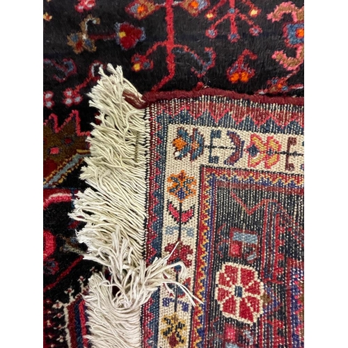 958 - A vintage mid 20th century Persian Islamic Hamadan floor carpet rug having geometric central medalli... 