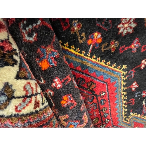 958 - A vintage mid 20th century Persian Islamic Hamadan floor carpet rug having geometric central medalli... 