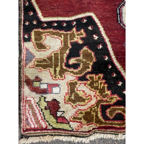 959 - A vintage 20th century 1930s / 40s Turkish Altakula hand knotted floor carpet rug having a geometric... 