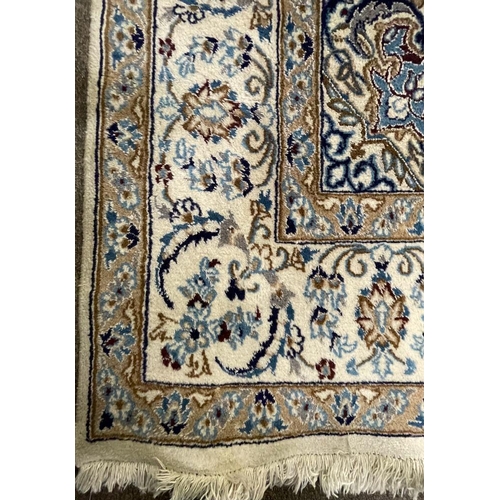 963 - A vintage late 20th century Persian Islamic Nain floor carpet rug having a central sun shaped medall... 