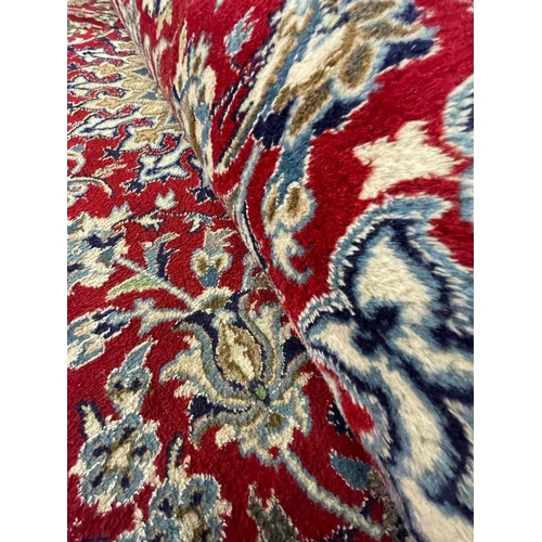 963 - A vintage late 20th century Persian Islamic Nain floor carpet rug having a central sun shaped medall... 